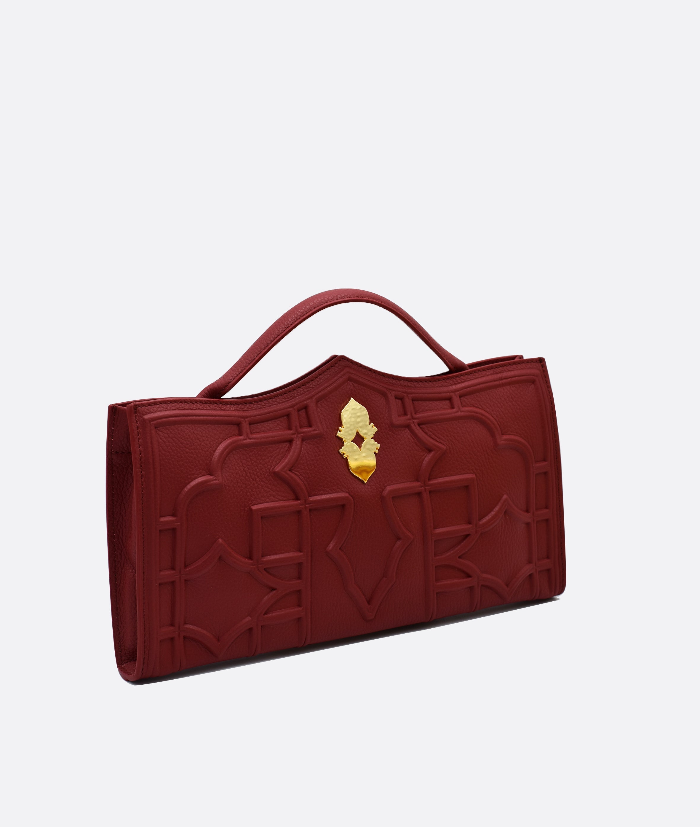 Verna  Venetian red clutch bag in premium calfskin leather, handcrafted in Venice. Features 18k gold-plated 'Leone e Stella' logo and embossed geometric pattern inspired by Venetian architecture.