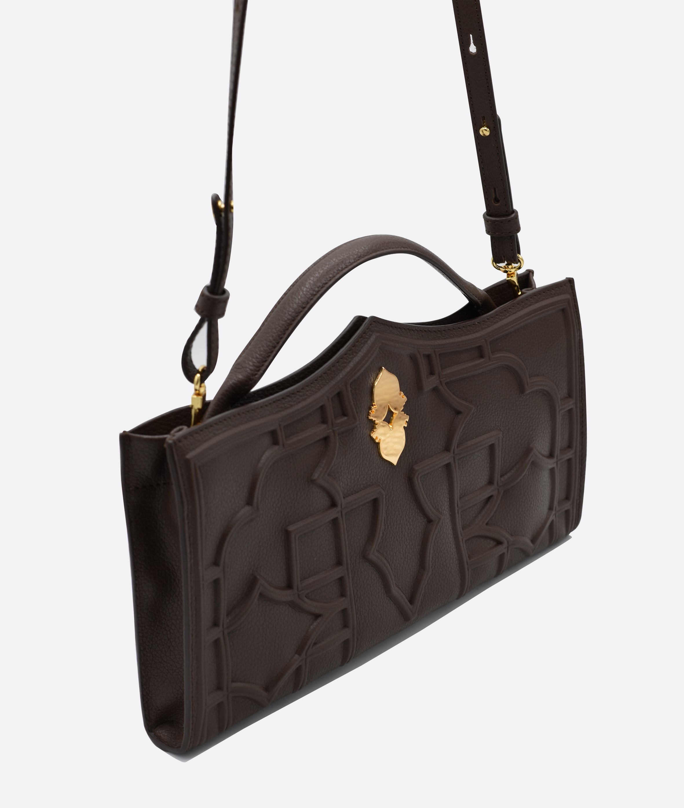 Verna chocolate clutch bag in premium calfskin leather, handcrafted in Venice. Features 18k gold-plated 'Leone e Stella' logo and embossed geometric pattern inspired by Venetian architecture.